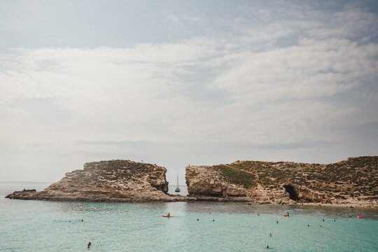 A sailboat seen through a rock cravasse