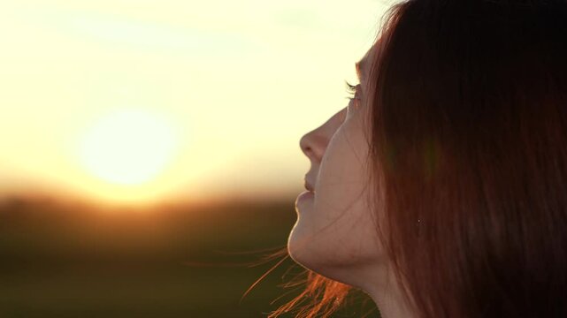 girl look sky sunset gaze, girl look sky thoughtful horizon, girl look sky golden hour reflection, woman praying god contemplating dusk, religious person profile against sun, woman face look up