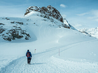 Hiking trail in the winter mountains, Swiss winter Alps