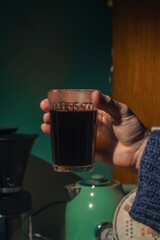 Experience the Warm and Inviting Coffee Moment with a Handheld Artisan Glass of Brew