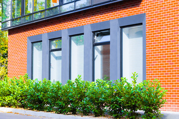 down town green city urban working office space idyllic landscaping garden floral environment red brick square shape pattern building with bush and plants in sunny bright vivid summer
