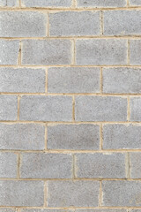 Abstract background of grey wall made of cinder blocks. Classic masonry blocks