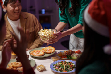 At New Year's Eve and Christmas Eve parties, Asian friends and coworkers come to celebrate together. Champagne, wine, popcorn, gift boxes, and festive decorations create a fun holiday atmosphere.