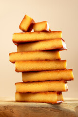Closeup shot of stacked toasted egg yolk turron bars, macro texture, hero shot on wooden podium