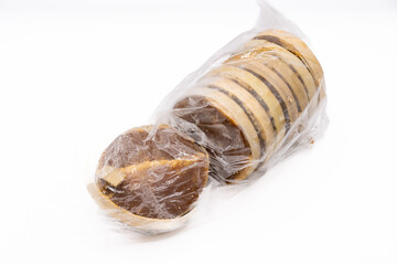 This image showcases a disc of Gula Melaka, a traditional Southeast Asian palm sugar, with a distinctive golden brown hue and a natural, textured surface.