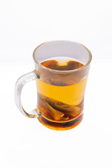 This image showcases a glass mug filled with a soothing herbal tea, its warm amber hue hinting at the natural flavors within.