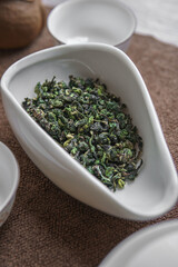 Delicate Dried Green Tea Leaves Beautifully Arranged in an Elegant Dish for Brewing