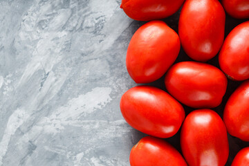 Ripe Red Tomatoes on Gray Concrete Surface for Farm-to-Table Mediterranean Cuisine, Top View, Copy Space