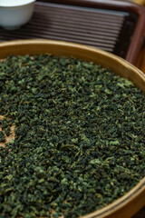 Dried Green Tea Leaves Placed Nicely on a Bamboo Tray for a Beautiful Presentation