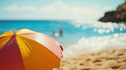 Sunny Beach Day with Vibrant Umbrella and Sparkling Water