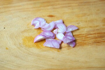sliced shallot or red onion on wooden cutting board