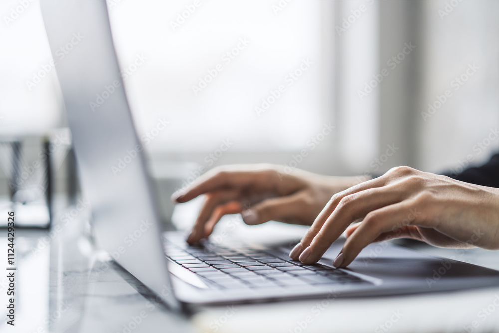 Poster the image captures female hands in close detail, typing on a sleek laptop keyboard, with a fuzzy off