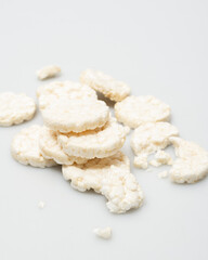 wheat rice breads, biscuits on a white background crumbled and whole