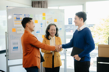 Group of young Asian business people discussing business plan at modern startup