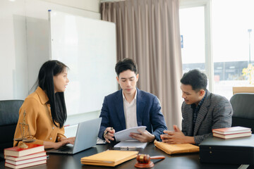 Asian lawyers in a modern office discussing contracts, law, and justice. Collaboration, documents, and determination showcased