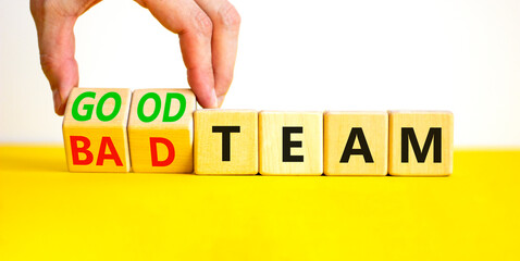 Good or bad team symbol. Concept words Good team Bad team on wooden cubes. Beautiful yellow table white background. Businessman hand. Business and good or bad team concept. Copy space.