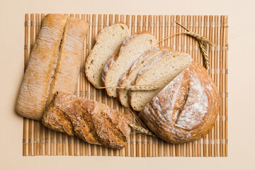 Freshly baked bread slices on napkin against natural background. top view Sliced bread