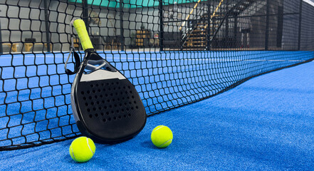 padel racket on a padel court with a ball