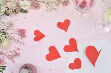 Seamless pattern with hearts, Valentine's Day, love, red hearts falling out of the envelope surrounded by flowers. Pink background.