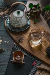 Beautiful and Elegant Tea Setting in a Cozy Style with a Glass Kettle and Wooden Tray for Enjoyment