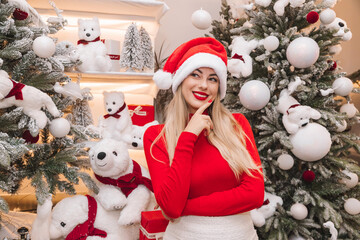 Cheerful woman in a Santa hat with Christmas decorations