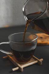 Pouring Freshly Brewed Coffee into a Clear Glass Cup with an Inviting Aroma and Appeal