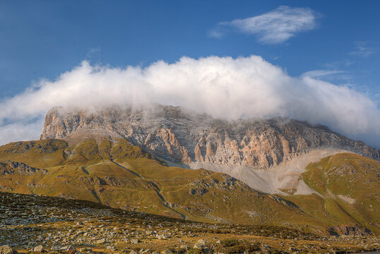 High mountain range. There are beautiful clouds above the mountains.