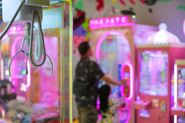 A Colorful Claw Machine Filled with Soft Plush Toys and Fun Offers.