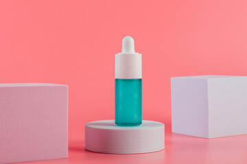 Blue glass cosmetic bottle, Skin care or sunscreen cosmetic on pink background.