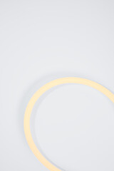 Flexible warm white led tape glowing on white background.