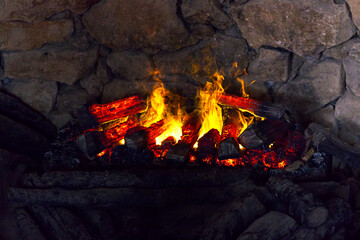 Photo of a flame in a fireplace. Burning fire in the fireplace. Fireplace, stove, burning wooden...