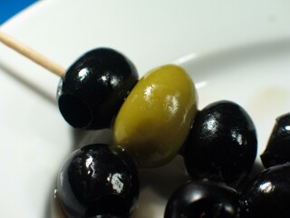 Black and green olives close view background