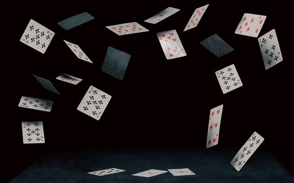 playing cards fall on a black table