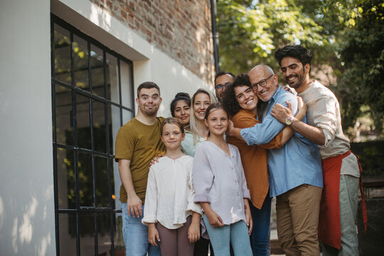 Diverse group of community members embracing successful community project