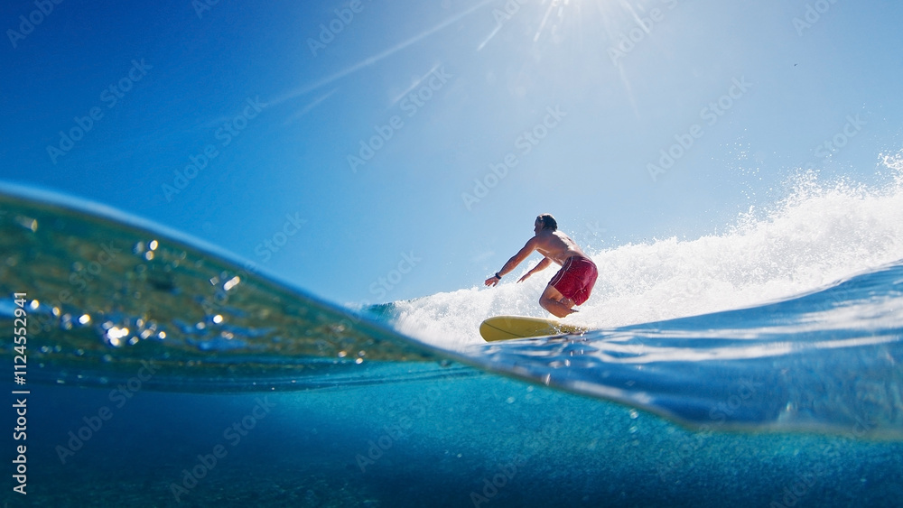 Aufkleber Surfer is riding a wave with the scene from above and below the surface. Maldives