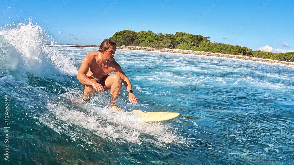Poster surfer skillfully navigating vibrant waves in a tropical ocean. maldives
