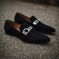 Sleek black suede loafers with a silver buckle.