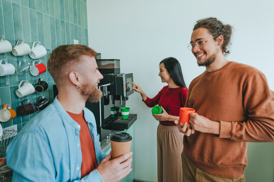 Happy business people having coffee in office cafeteria - Powered by Adobe