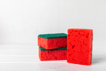 Colorful dish sponges on textured background. Kitchen sponge. Cleaning concept, cleaning service. Dishwashing liquid with clean and dirty dishes plate. Place for text, copy space. Wash the dishes.