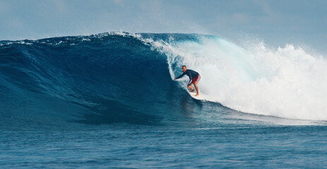 Pro surfer rides big wave in the Maldives