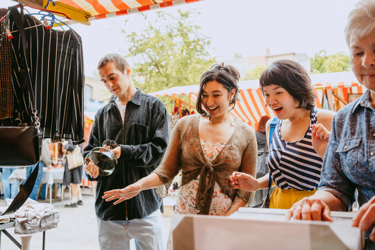 Group of people shopping at an outdoor flea market.