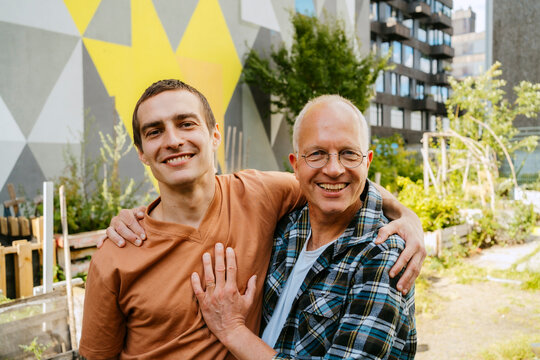 Two people bonding in an urban gardening area outdoors.