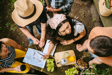 Small group of people planning urban gardening project outdoors.