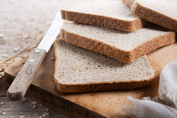 Healthy wholemeal bread slices on wooden table