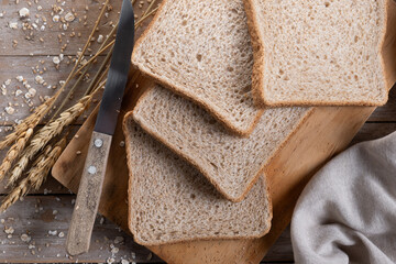 Healthy wholemeal bread slices on wooden table