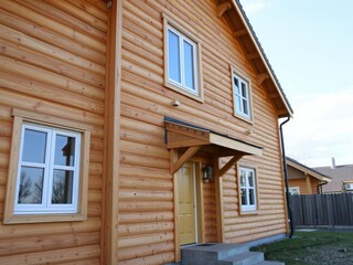 Wall construction with insulating wood cladding, creating energy-efficient and aesthetically pleasing exterior facade, cladding, architecture