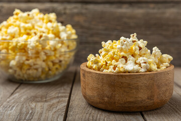 Salty popcorn on bright color background. Cinema and entertainment concept. Movie night with popcorn. Delicious appetizer, snack.Space for text, copy space. Banner