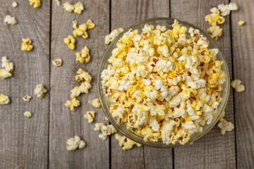 Salty popcorn on bright color background. Cinema and entertainment concept. Movie night with popcorn. Delicious appetizer, snack.Space for text, copy space. Banner
