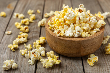 Salty popcorn on bright color background. Cinema and entertainment concept. Movie night with popcorn. Delicious appetizer, snack.Space for text, copy space. Banner