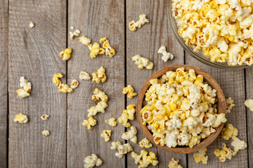 Salty popcorn on bright color background. Cinema and entertainment concept. Movie night with popcorn. Delicious appetizer, snack.Space for text, copy space. Banner